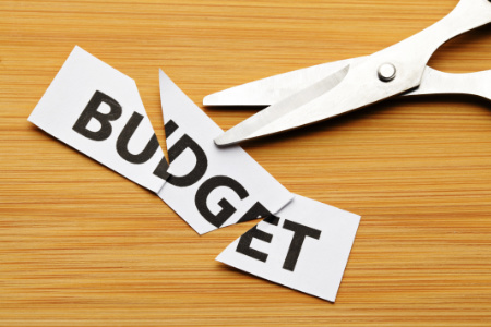 Scissors cutting up the word budget